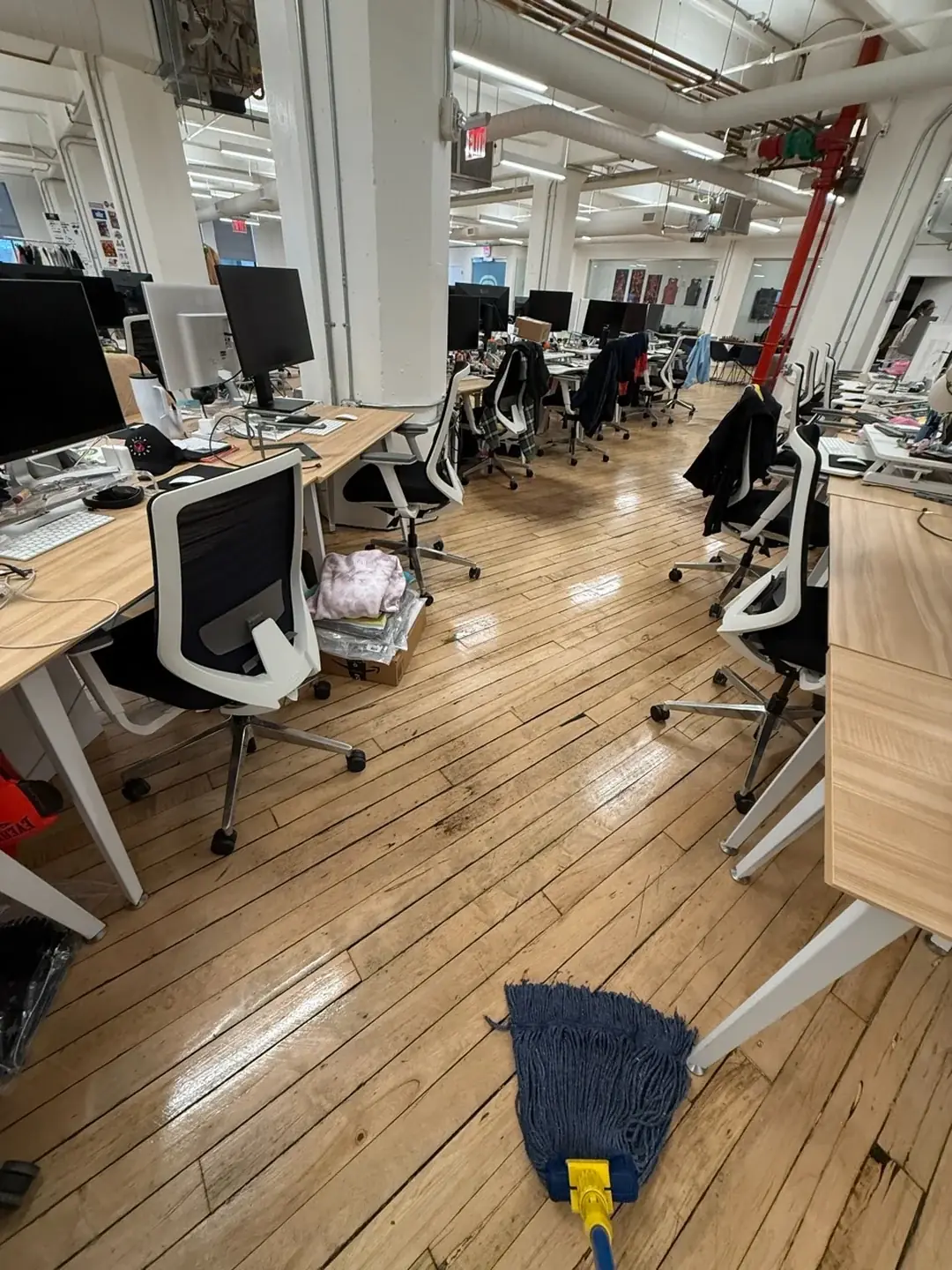 Cleaner mopping an open-plan office