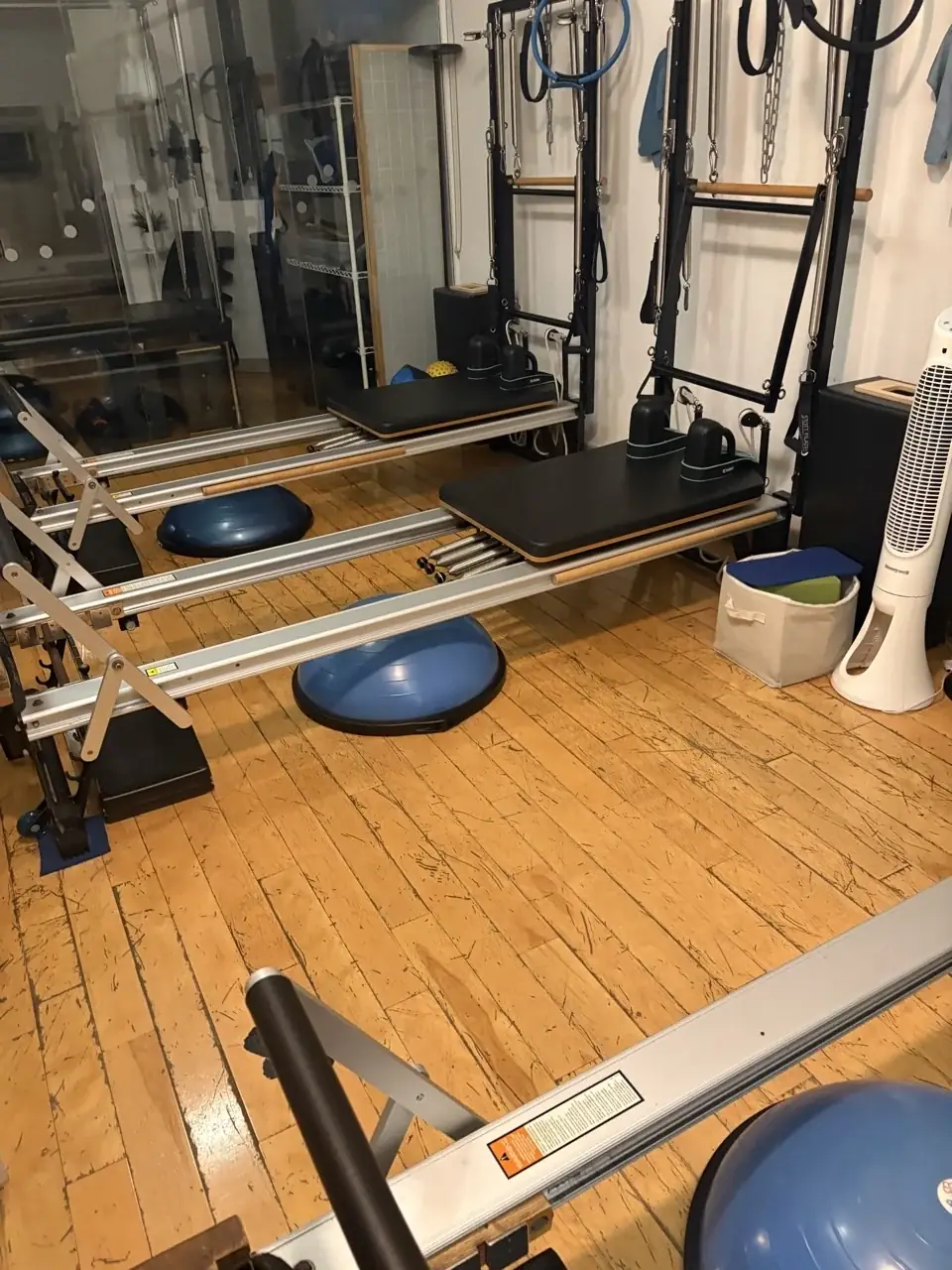 Cleaned Pilates studio floor and reformers