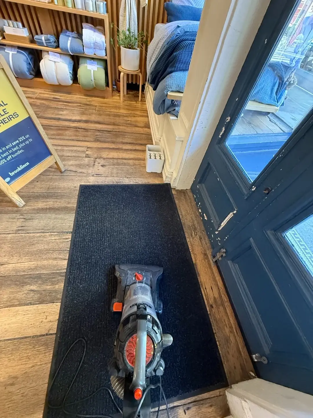 Baymark cleaner vacuuming a store entrance