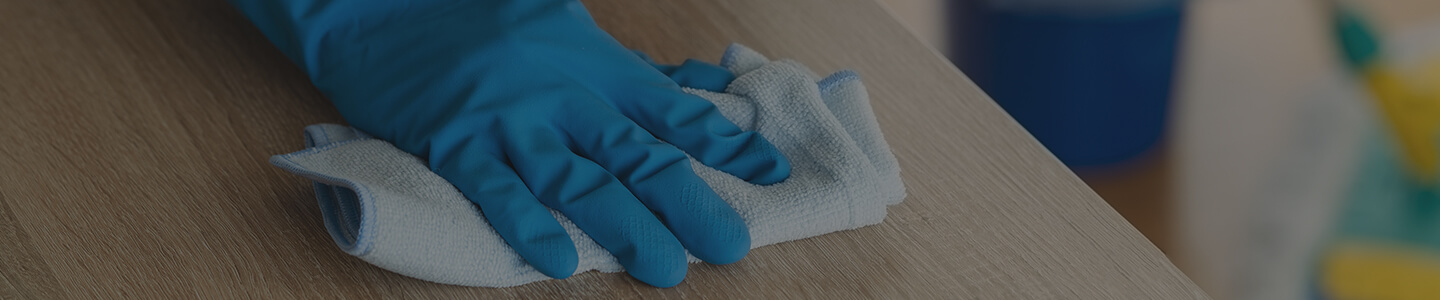 man with cloth wiping counter