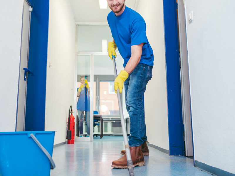 man sweeping floor