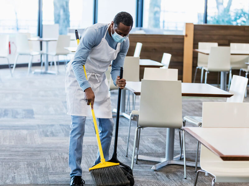 man sweeping floor