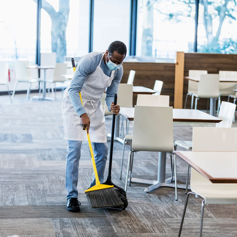 man sweeping floor