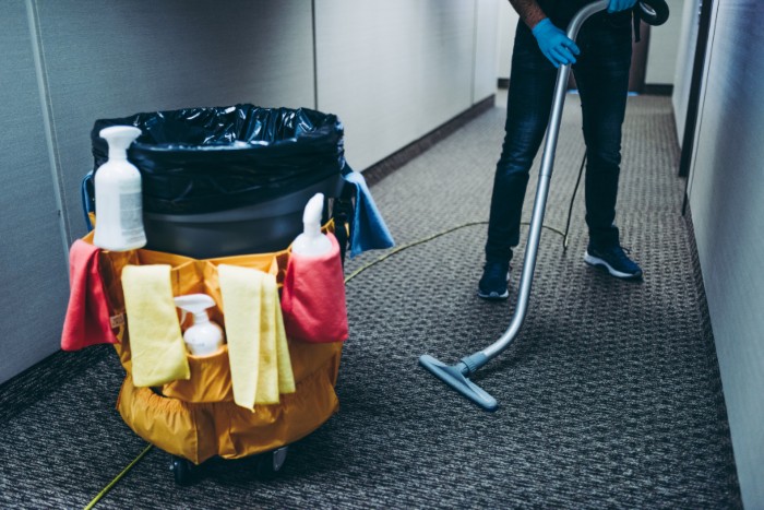 A person vacuuming an office in New York