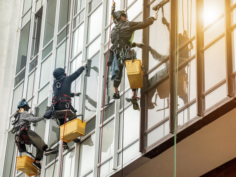 a men cleaning a retail window in nyc